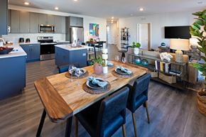 Pennington apartment for rent - a kitchen and dining room with blue cabinets and a wooden table