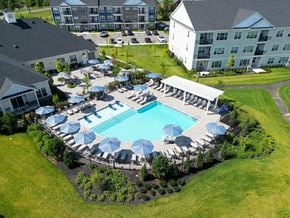 Pennington apartment for rent - an aerial view of a swimming pool with umbrellas and chairs at the resort