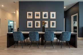 Pennington apartment for rent - a dining room with a long table and blue chairs