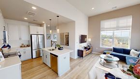 Randolph apartment for rent - A modern kitchen with white cabinets and a wooden island.