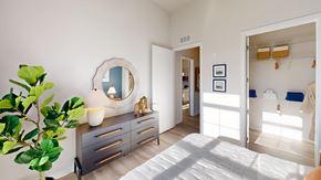 Randolph apartment for rent - A bedroom with a bed, dresser, mirror and a plant.
