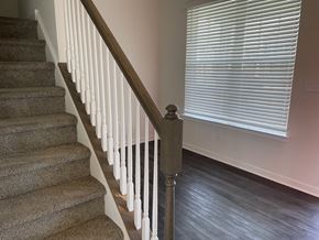 Dover apartment for rent - a staircase in a home with a large window and a stairwell with a railing