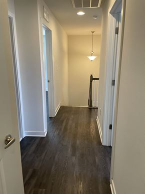 Dover apartment for rent - a look down the hallway of a new home with wood flooring