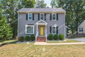 Henrico house for rent - A house with a grey facade and a yellow door.