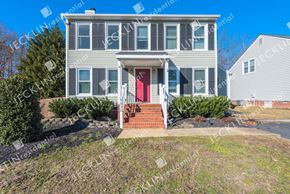 Henrico house for rent - A house with a red door and a brick staircase leading to it.