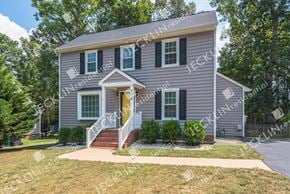 Henrico house for rent - A house with a grey exterior and a yellow door.