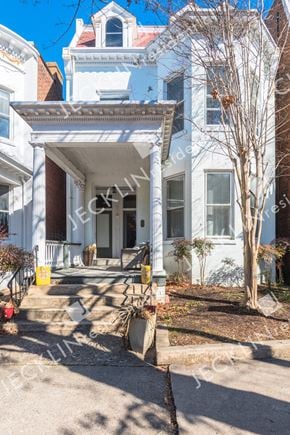 Richmond house for rent - A white house with a porch and a tree in front.