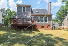 Henrico house for rent - A house with a grey exterior and a brown deck.