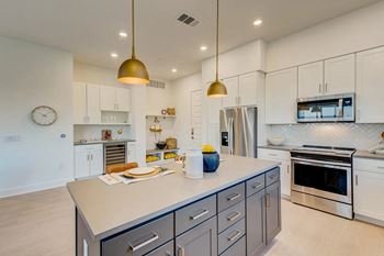Shaker-style cabinetry with quartz countertops in kitchen and baths