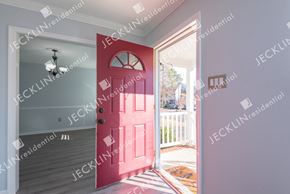 Henrico house for rent - A red door is in the middle of a white wall.