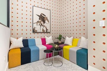 Austin apartment for rent - a living room with colorful couches and a painting on the wall