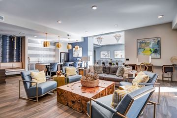Richmond apartment for rent - A living room with a blue chair and a wooden coffee table.