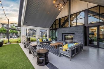 Outdoor entertainment lounge with fireplace, tvs