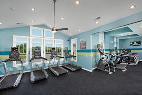 Concord apartment for rent - a gym with cardio machines and windows and a ceiling fan