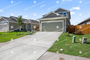 Bastrop house for rent - a row of houses on a street with a clear blue sky in the background