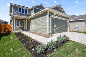 Bastrop house for rent - a craftsman style house with gray siding and a blue roof