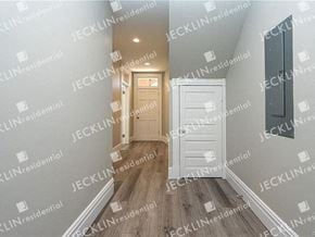 Richmond house for rent - a hallway with a white door and hardwood floors