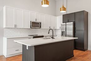 Nashville apartment for rent - A kitchen with white cabinets and a black refrigerator.
