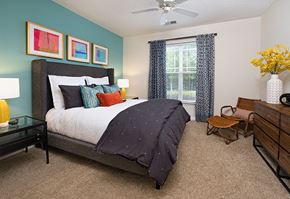 Davidson townhouse for rent - A bedroom with a bed, nightstand, and a chair.