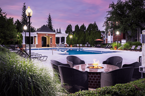 Concord apartment for rent - A poolside table with a fire pit in the middle of it.