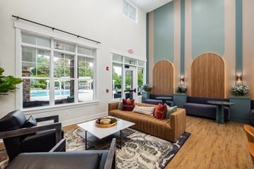 Charlotte apartment for rent - a living room with couches and chairs and a table