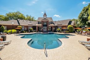 Huntersville townhouse for rent - A large swimming pool in front of a house.