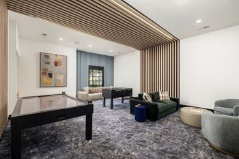 24-Hour game room with air hocky and foosball tables with comfy seating