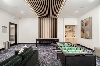 24-Hour game room with air hocky and foosball tables with comfy seating