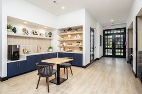 Charlotte apartment for rent - A modern kitchen with a dining table and chairs.