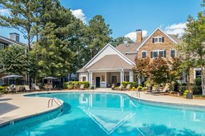 Charlotte apartment for rent - A large house with a pool in front.