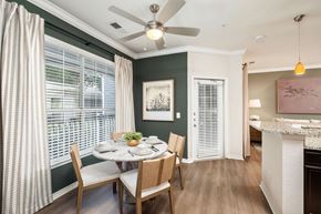 Charlotte apartment for rent - A dining room with a table set for four and a ceiling fan.
