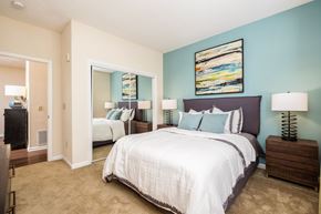 Charlotte apartment for rent - A bedroom with a large bed and a painting on the wall.