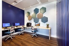 Concord apartment for rent - a conference room with two desks and three computer monitors