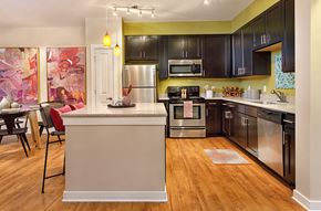 Concord apartment for rent - a kitchen with stainless steel appliances and black cabinets