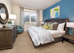 Concord apartment for rent - a bedroom with blue walls and a bed with pillows