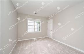 Henrico house for rent - A sparsely furnished room with a window and a door.
