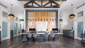Nashville apartment for rent - A modern office space with a long table and chairs.