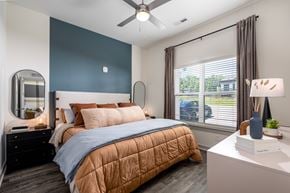 Nashville apartment for rent - A bedroom with a bed, nightstand, and window.