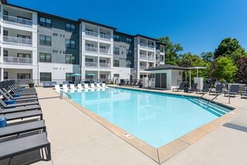 Nashville apartment for rent - A large swimming pool in front of a multi-story apartment building.