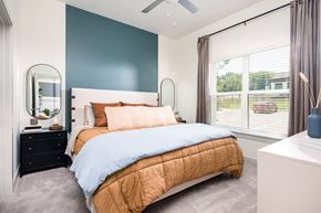 Nashville apartment for rent - a bedroom with a bed and a dresser with a mirror