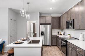 Gallatin apartment for rent - A modern kitchen with a stainless steel refrigerator and wooden cabinets.
