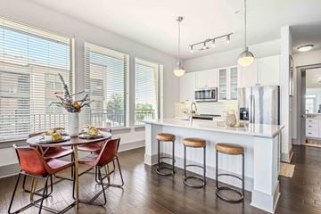 Grapevine apartment for rent - an open kitchen with a breakfast bar and a table with chairs