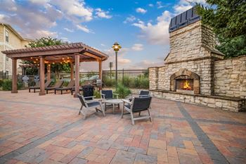 Outdoor lounge with fireplace with comfy seating