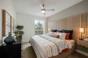 Fort Worth apartment for rent - a bedroom with a bed and a ceiling fan