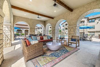 Poolside outdoor lounge with fireplace and grills
