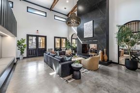 Grand Prairie apartment for rent - A modern living room with a grey sofa and a black coffee table.