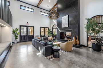 Grand Prairie apartment for rent - A modern living room with a grey sofa and a black coffee table.
