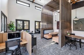 Grand Prairie apartment for rent - A modern office space with wooden slats on the wall and a variety of seating options.