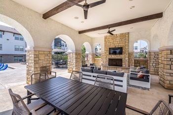 Poolside outdoor lounge with fireplace and grills