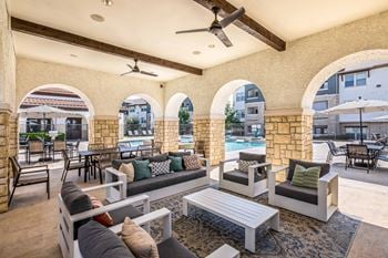 Poolside outdoor lounge with fireplace and grills